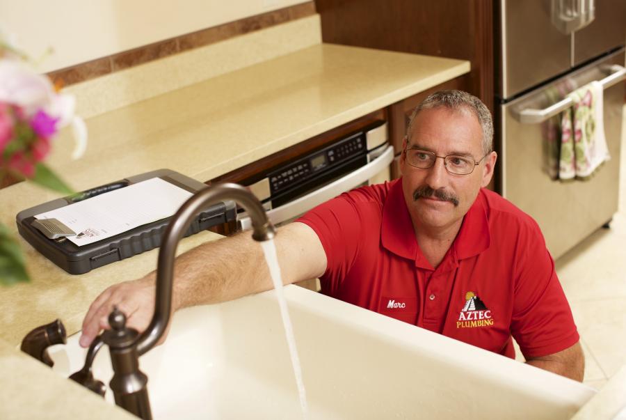 Aztec plumber working on sink & garbage disposal