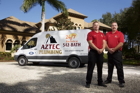 two Aztec Plumbing employees in front of van outside of Florida Home