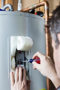 plumber flushing out water heater