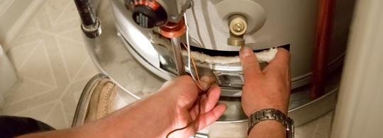 Plumber working on a water heater