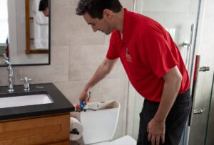 Technician working on toilet